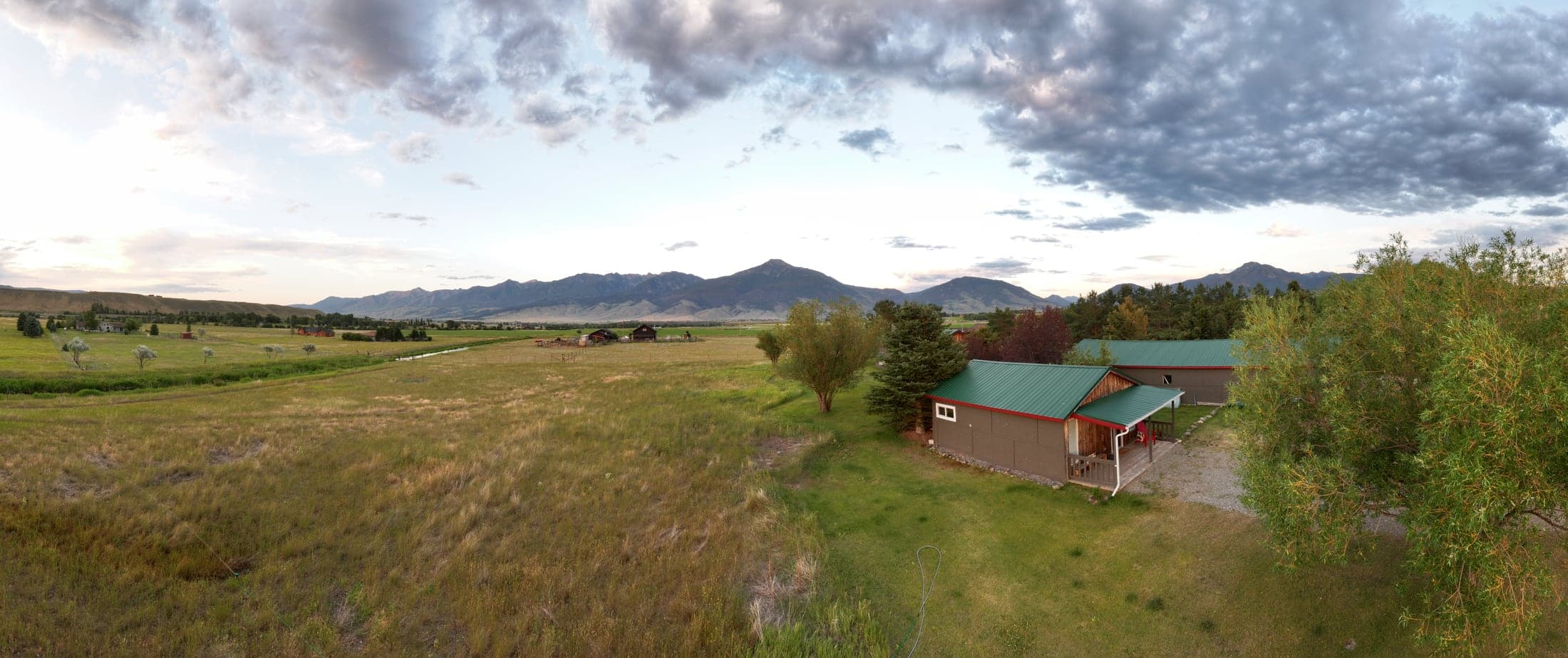 Aerial view of The Cottage on family land in Paradise Valley with mountain views and dark sky